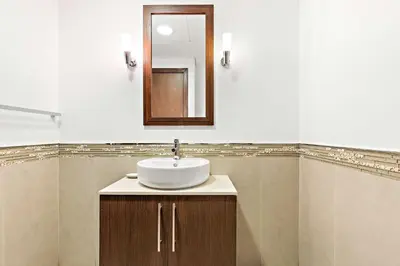 a bathroom with a sink and a mirror at Silkhaus Burj Khalifa & Zaabeel View in Burj Daman in Dubai