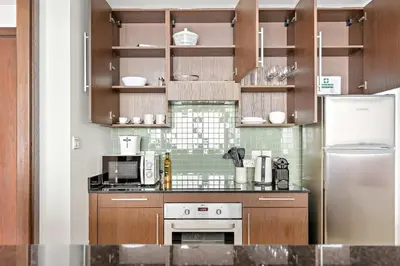 a kitchen with a stove and a refrigerator at Silkhaus Burj Khalifa & Zaabeel View in Burj Daman in Dubai