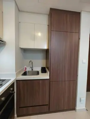 a kitchen with wooden cabinets and a sink at Cozy 2BR Apartment DAMAC VERA Business Bay in Dubai