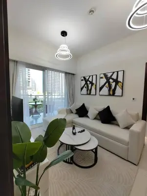 a living room with a couch and a table at Cozy 2BR Apartment DAMAC VERA Business Bay in Dubai