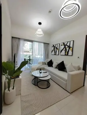 a living room with a couch and a table at Cozy 2BR Apartment DAMAC VERA Business Bay in Dubai