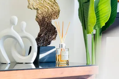 a shelf with a bottle of perfume and some vases at The Magnificent in Dubai