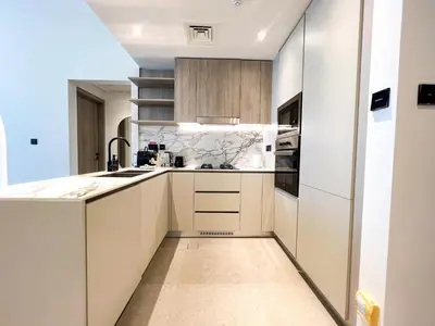 a kitchen with white cabinets and a sink at 1-BR Gem with Luxe Amenities in JVC in Dubai