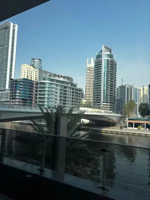 a bridge over a river in a city with tall buildings at Sparkle Skyline Studio - Contemporary Living in Dubai