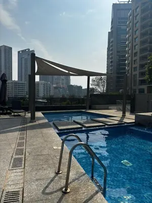 a swimming pool on the roof of a building at Sparkle Skyline Studio - Contemporary Living in Dubai