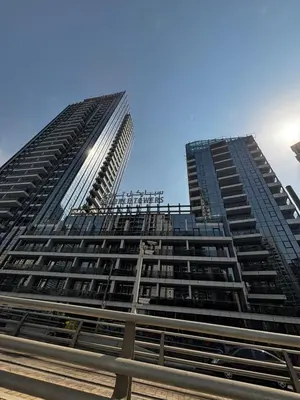 a tall building with a blue sky in the background at Sparkle Skyline Studio - Contemporary Living in Dubai