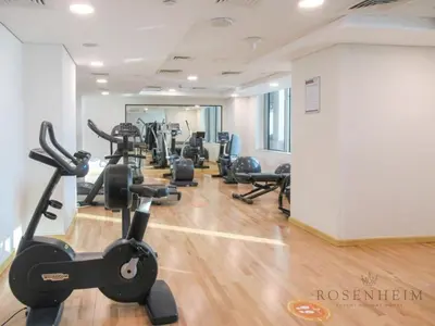 a gym with several treadmills and exercise bikes at Sparkle Skyline Studio - Contemporary Living in Dubai