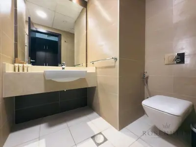 a bathroom with a sink and a toilet at Luxury Canal View Studio at Sparkle Tower in Dubai
