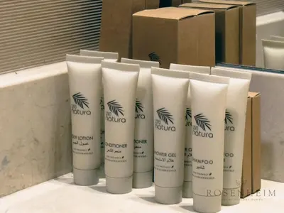 a group of four white tubes of hairbrushes at Luxury Canal View Studio at Sparkle Tower in Dubai
