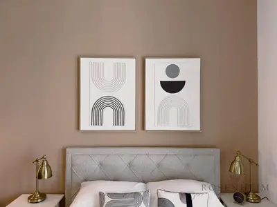a bedroom with two pictures on the wall above a bed at Luxury Canal View Studio at Sparkle Tower in Dubai