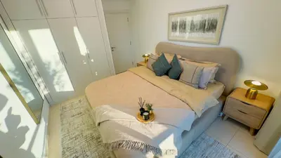 a bedroom with a bed with a flower on it at Skyline Dream - 1 BHK - Burj and Canal views in Dubai