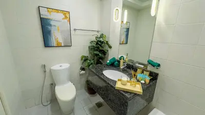 a bathroom with a sink and a toilet at Skyline Dream - 1 BHK - Burj and Canal views in Dubai
