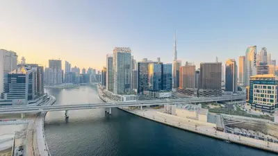 a view of a city with a river and a bridge at Skyline Dream - 1 BHK - Burj and Canal views in Dubai