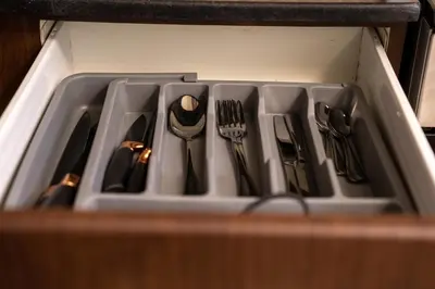 a drawer filled with utensils in a kitchen at Skyline Dream - 1 BHK - Burj and Canal views in Dubai