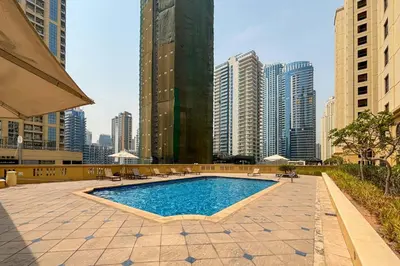 a pool in the middle of a city with tall buildings at Frank Porter - Murjan 1 in Dubai
