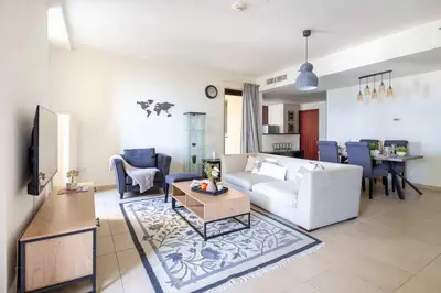 a living room with a couch and a table at Frank Porter - Murjan 1 in Dubai