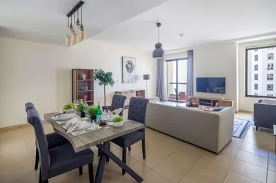a living room with a table and a couch at Frank Porter - Murjan 1 in Dubai