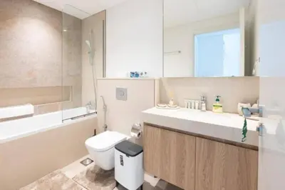 a bathroom with a toilet and a sink and a tub at Downtown Dubai views 2 tower 1 in Dubai