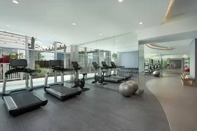 a gym with treadmills and exercise equipment in a building at Downtown Dubai views 2 tower 1 in Dubai