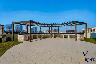a pavilion on top of a building with a city skyline at Stylish and Cozy Studio Apartment in Dubai