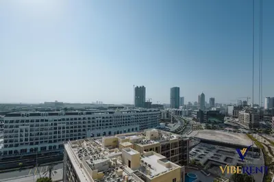 an aerial view of a city with buildings and roads at Stylish and Cozy Studio Apartment in Dubai