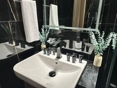 a bathroom with a white sink and a mirror at Sleek & Spacious 1br Jvc Pool View in Dubai