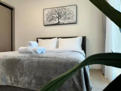 a bedroom with a bed with two towels on it at Sleek & Spacious 1br Jvc Pool View in Dubai
