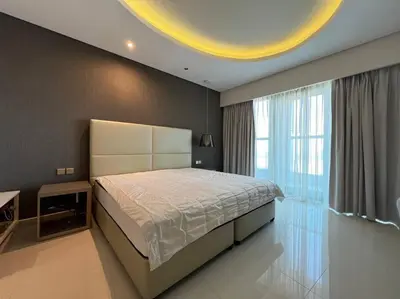 a bedroom with a large bed and a large window at Luxurious & Modern 1BR DAMAC Paramount Business Bay in Dubai
