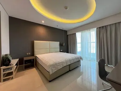 a bedroom with a bed and a large window at Luxurious & Modern 1BR DAMAC Paramount Business Bay in Dubai