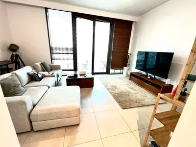 a living room with a couch and a flat screen tv at Downtown views-access to Dubai Mall! in Dubai