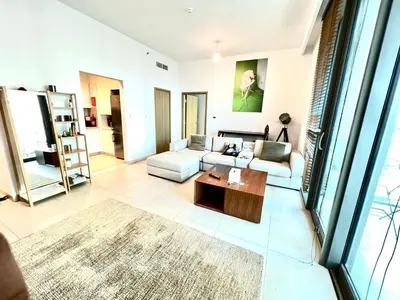 a living room with a couch and a table at Downtown views-access to Dubai Mall! in Dubai