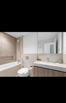 a bathroom with a toilet and a tub and a sink at Downtown views-access to Dubai Mall! in Dubai