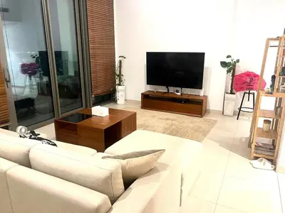 a living room with a couch and a flat screen tv at Downtown views-access to Dubai Mall! in Dubai