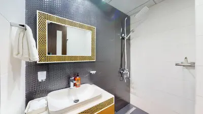 a bathroom with a sink and a mirror at Modern Studio in Business Bay in Dubai