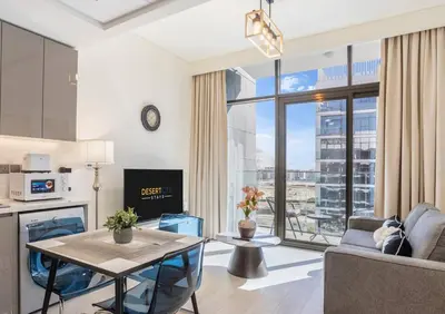 a living room with a table and a large window at Fully Furnished One Bed in Meydan, Hosted by Desert City Stays in Dubai