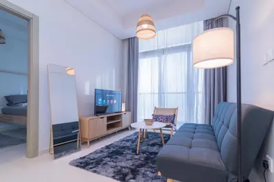 a living room with a couch and a tv at Samani vacation Homes 5701 in Dubai