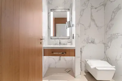 a bathroom with a toilet and a sink and a mirror at Address Residence Dubai Opera 25 by Luxstay Holiday Homes in Dubai