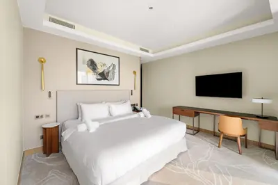 a bedroom with a bed and a desk and a television at Address Residence Dubai Opera 25 by Luxstay Holiday Homes in Dubai