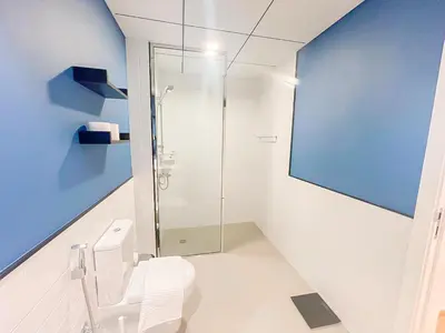 a bathroom with a glass shower and a toilet at Luxury 2 Bedroom in the Nook 1 next to Metro Energy in Dubai