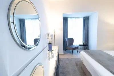 a bedroom with a bed and a mirror on a wall at Elite Residences Tower Dubai Marina by Happy Season in Dubai
