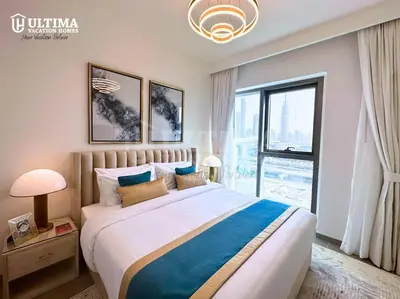 a bedroom with a large bed with a large window at Elegant 2BR Burj Khalifa view-Downtown Views II in Dubai