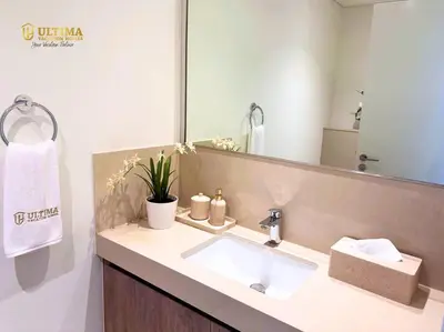 a bathroom with a sink and a large mirror at Elegant 2BR Burj Khalifa view-Downtown Views II in Dubai