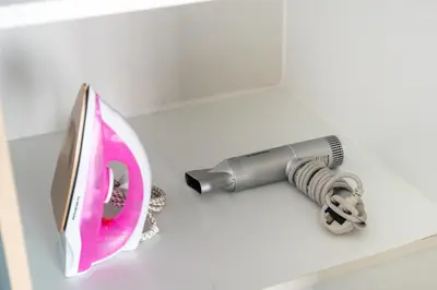 a hair dryer and a blow dryer on a counter at Urban Designer Apt - Family Friendly in Dubai