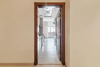 a hallway with a door leading into a room at Urban Designer Apt - Family Friendly in Dubai