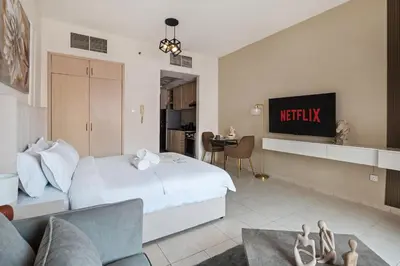 a hotel room with a bed and a tv at Urban Designer Apt - Family Friendly in Dubai