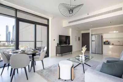 a living room with a dining table and a kitchen at Frank Porter - Marina Vista tower 2 in Dubai