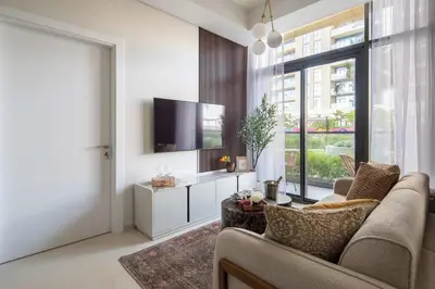 a living room with a couch and a tv at Frank Porter - Aykon City Tower C in Dubai