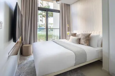 a bedroom with a large white bed with a window at Frank Porter - Aykon City Tower C in Dubai