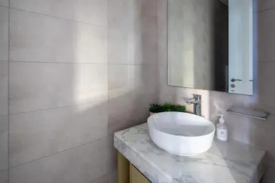 a bathroom with a white sink and a mirror at Frank Porter - Aykon City Tower C in Dubai