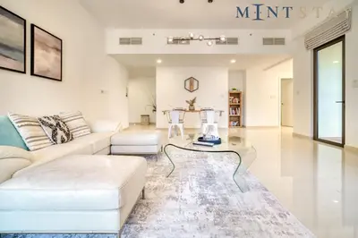 a living room with a white couch and a glass table at Bahar, Jumeirah Beach Residence JBR - Mint Stay in Dubai